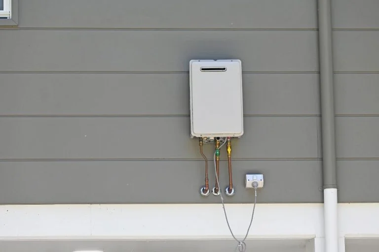 A hot water sytem placed on a residential house.